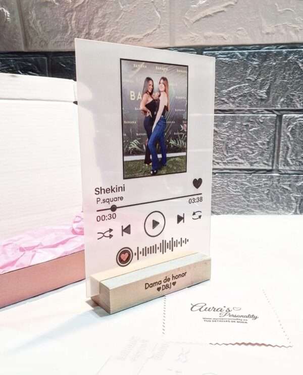 Regalo Personalizado para Dama de Honor: Placa Transparente con Canción Especial Sorprende a tu dama de honor con un regalo único y lleno de significado. Esta placa personalizada es perfecta para dedicar una canción especial que celebre su papel en tu gran día. Con detalles elegantes y una presentación impecable, este regalo será un recuerdo inolvidable. ¿Qué Incluye Este Regalo? 1. Placa Transparente Personalizada Medidas: 17,5 x 12 x 5 cm, ideal para exhibir en cualquier espacio. Material premium: Confeccionada en acrílico transparente de alta calidad para un acabado elegante y duradero. Personalización especial: Incluye el título de una canción significativa, un nombre o dedicatoria, y detalles únicos que harán de esta placa un regalo exclusivo. 2. Soporte de Madera Personalizado Base estable y elegante: Diseñada para sostener la placa con seguridad y estilo. Personalización adicional: Graba un nombre o mensaje especial en el soporte para complementar el diseño. 3. Caja de Presentación Empaque premium: Incluye una caja elegante que realza la presentación y lo convierte en un regalo listo para entregar. Ideal para regalar: Perfecta para añadir un toque de sorpresa y emoción. ¿Por Qué Es Perfecto para una Dama de Honor? ✔ Un Regalo Emotivo y Personalizado La posibilidad de incluir una canción significativa, junto con nombres o dedicatorias, hace que este regalo sea único y lleno de valor sentimental. ✔ Elegancia y Versatilidad El diseño minimalista y sofisticado combina con cualquier estilo de decoración, lo que lo convierte en un recuerdo perfecto para exhibir en casa o en el lugar de trabajo. ✔ Hecho a la Medida Cada detalle está diseñado para reflejar la importancia del rol de tu dama de honor en tu boda, haciéndola sentir valorada y especial. Ideas para Dedicatorias o Canciones 🎵 Canciones: Elige una canción significativa que represente vuestra amistad o un momento especial compartido. 💌 Dedicatorias: "Gracias por estar a mi lado en cada paso del camino" o "Dama de honor, amiga y mi mayor apoyo". Materiales y Cuidados Material principal: Acrílico transparente, fácil de limpiar y mantener. Base de madera: Mantenla en un lugar seco y límpiala con un paño suave. Recomendación: Evita colocar la placa en lugares expuestos al sol directo para preservar su brillo y claridad. Haz Tu Pedido Hoy y Sorprende con Este Regalo Único Este regalo personalizado para dama de honor es una forma elegante y significativa de agradecer su apoyo en tu día especial. ¡Añádelo a tu carrito ahora y crea un recuerdo que durará para siempre!